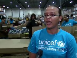 INTERVIEW - Jennifer Aho-Glele on how its empowering to help the mission and being part of a global community at Local Volunteers in Carteret, NJ Help UNICEF & UPS Pack Winter for Syrian Children Stock Footage