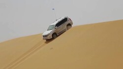 Car over sand dunes in desert /Alashan, Inner Mongolia, China. Stock Footage