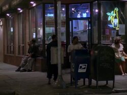 MS PAN near corner store, people leaning outside stores window and sidewalk & car traffic/ Philadelphia, Pennsylvania, United States  Stock Footage