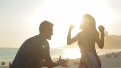 Young Brazilian couple dance in the sunlight on the beach at Ipanema Stock Footage