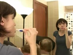 Couple brush teeth and talk Stock Footage