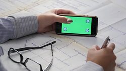 Architect's Hands and Touch Screen Over a Blueprints Stock Footage