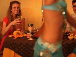 Good looking young couple have dinner with belly dancer Stock Footage