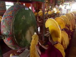 MS ZI ZO Young monk banging on  large drum  AUDIO / Kathmandu, Central Region, Nepal  Stock Footage