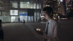 Man using mobile phone at night in the city Stock Footage