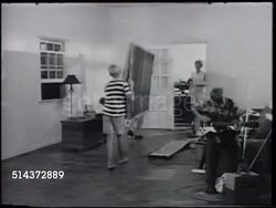 1966: FERNE WINBORNE: CU Teen hand strumming electric guitar, ZO WS Family arranging empty room, husband & father moving pegboard panel w/ son, CU Labrador Retriever dog, daughter dusting small items, Ferne standing by wall, smiling, talking. Instructional Video
