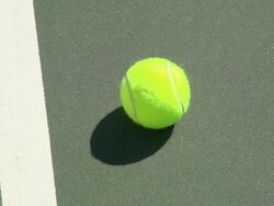 A tennis ball on a tennis court. - Slow Motion Stock Footage
