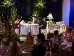 DOLLY WS Bride and groom, best man and maid of honor seated at head table, other guests seated at their tables Stock Footage
