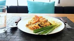 Phud thai (Thai noodle) on dining table Stock Footage