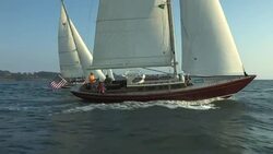 Three sailboats sail in tandem across Narragansett Bay near Castle Hill in Rhode Island. Stock Footage
