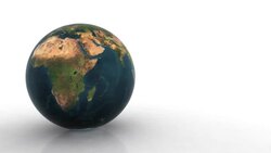 A blue, green and brown Earth spins on a white surface. Stock Footage