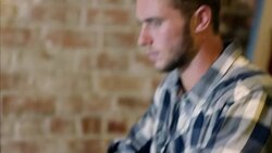 Young man types on laptop computer Stock Footage