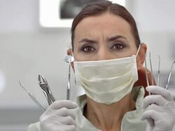 HD DOLLY: Dentist Showing Her Tools Stock Footage