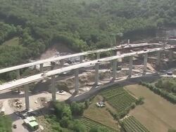 AERIAL over highway construction site on edge of forest/ Slovenia Stock Footage