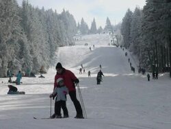 WS View of skier and snowboarder on piste, winter sport and snow ski lift / Erbeskopf, Hunsruck, Rhineland Palatinate, Germany Stock Footage