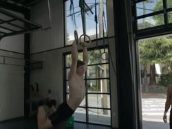 Camera tracks in as Casey performs series of muscle-ups. Stock Footage