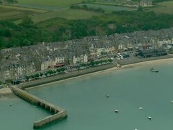 AERIAL, Pier and waterfront houses, Cancale, Brittany, France Stock Footage
