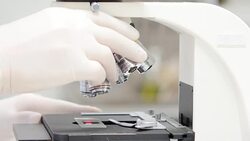 Scientist is using with microscope Stock Footage