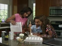 'Slow motion of mother, boy, and girl mixing ingredients.' Stock Footage