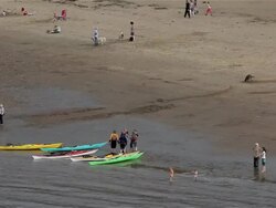 CANOES AND PEOPLE ON EAST CLIFF BEACH Stock Footage