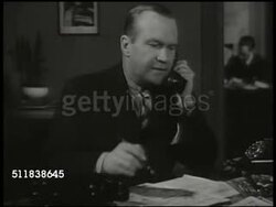 1944: STOCKHOLM, SWEDEN: DRAMATIZATION: 'Swedish Press man' sitting at desk looking over papers, calling Berlin associate. Associate talking about what's happening in Berlin (Swedish), holding phone receiver away from body, SOT bomb falling. Instructional Video