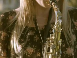 CU PAN teenage girl pressing air into mouthpiece of saxophone while her fingers hit upper and lower register keys / Redlands, California, USA Stock Footage
