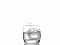 Pill falling into a Glass of Water against white background, Slow motion Stock Footage