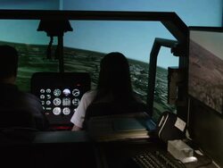 WS PAN student pilots in helicopter flight simulator; PAN starts on instructor's station and moves to the flight crew, RED R3D 4K Stock Footage