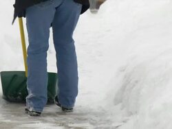 MS Woman in jeans shoveling snow from walkway / Saint Paul, Minnesota, United States  Stock Footage