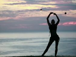 MS Woman poi dancer performing in front of pool with reflection of his silhouette in pool at sunrise / Montezuma, Costa Rica Stock Footage