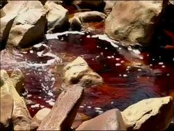 Water stained red by mineral ores (iron & other minerals at very high pH), Rio Tinto, Huelva, Andalusia, Spain Stock Footage