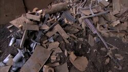 Broken pipe, chunks of concrete and other rubble fill a ditch. Stock Footage