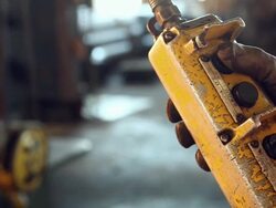 Worker pressing buttons on remote control panel in factory Stock Footage