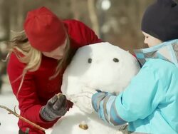 Family builds a snowman Stock Footage