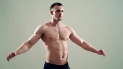 healthy athlete  with nice muscle on grey  background Stock Footage