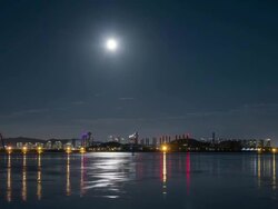 Night scenery of Cheongnashindosi city and the full moon in the sky from the sea near Yeongjong-do Stock Footage