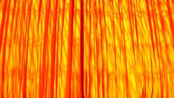 A light breeze rustles strands of newly-dyed fabrics hanging out to dry. Stock Footage