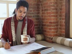 MS Architect using tablet and looking at blueprints in cafe / Santa Fe, New Mexico, United States Stock Footage