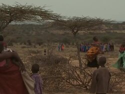 Maasai Ceremony - Young warriors and women dancing, singing at dawn, WITH AUDIO Stock Footage