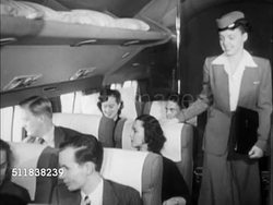 1950: TRANSPORTATION: Female flight attendant (stewardess) checking on passengers in First Class seats of DC-6, giving pillow to woman, handing another woman copy of 'Life' magazine covered in hard mag cover. Instructional Video