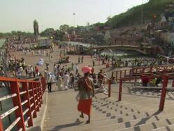 WS Man walking down steps to near of Ganges river / Haridwar, Uttarakhand, India Stock Footage