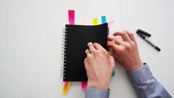 Timelapse of a man putting post it notes into a notepad Stock Footage