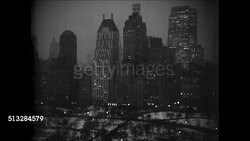 1937: NEW YORK CITY: NIGHT: XHA WS Skyscrapers lining Central Park. STREET SCENE: Cars parked curbside, businesses w/ neon lights on. Instructional Video