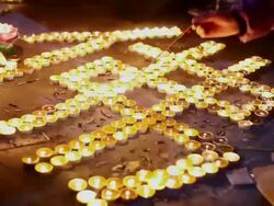 CU Shot of candles placed into Chinese Buddha in temple / Xian, China Stock Footage