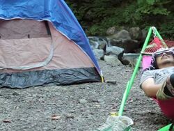 MS PAN Shot of tent and man resting / Okutama, Tokyo, Japan Stock Footage