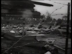 B/W 1960's wide shot PAN of ruins of destroyed village / Vietnam / SOUND Stock Footage