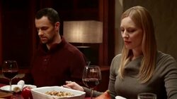 Woman saying grace before Thanksgiving meal with family at table Stock Footage