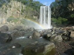 MS Jeongbang Falls and rainbow / Jeju-do, South Korea Stock Footage