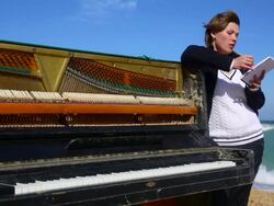 young woman writes on the coast Stock Footage