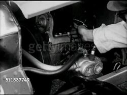 MOT: AMERICANA: TURN OF THE CENTURY REENACTMENT: MS Male hand touching motor parts under raised hood of 'Horseless Carriage' automobile. XWS Male checking auto in front of HUGE house, boarding or hotel. Instructional Video